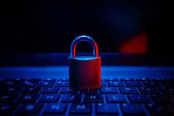 Cybersecurity lock on a keyboard in dim lighting