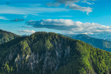 From rocky perch in Gailtal Alps, breathtaking panorama unfolds, revealing majestic peaks of...