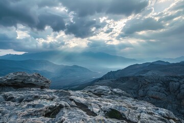 Majestic mountain landscape at dawn with dramatic clouds and distant hills