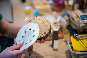 cute teen girl at a master class making a craft from wood, exhibition of crafts, crafts fair, education, master classes