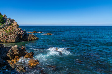 View of the rocky seaside with surf