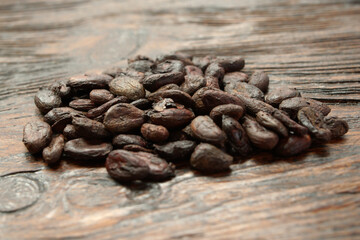 Broken dark chocolate and cocoa beans on the table