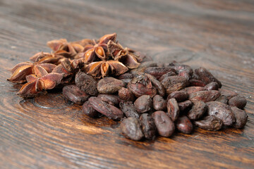 Broken dark chocolate and cocoa beans on the table