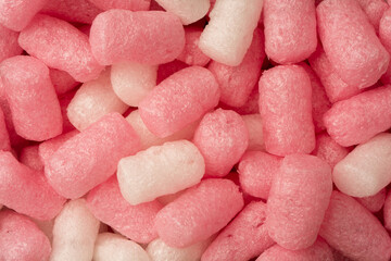 Pink and white box filler as a background. Top view.