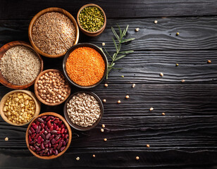 Uncooked pulses,grains and seeds in White bowls over wooden background. selective focus 