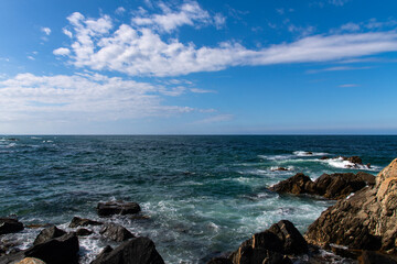 View of the rocky seaside with surf