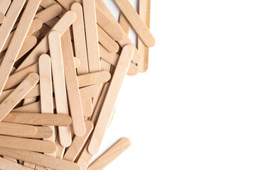 Wooden popsicle sticks on white background. View from above.