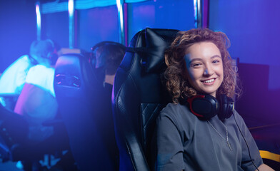 Portrait Female athlete gamer enjoys cyber game in esports setting with friends