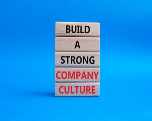 Company culture symbol. Wooden blocks with words Build a strong company culture. Beautiful blue background. Business and Company culture concept. Copy space.