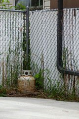 Propane tank in an abandoned yard