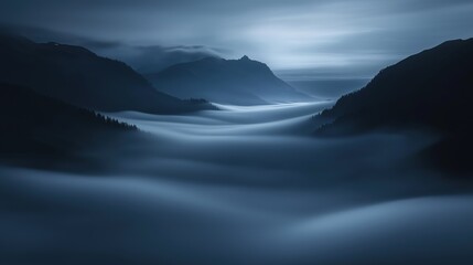 Naklejka premium Landscape photograph of a mountain range at night. the sky is dark and cloudy, and the mountains are silhouetted against the horizon.