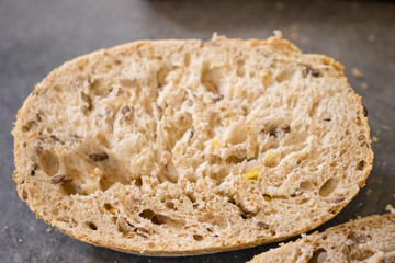 Close-up of a sliced bread revealing a textured interior, perfect for showcasing artisanal baking or culinary themes.