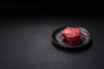 Raw beef tenderloin ribeye steak with salt and spices