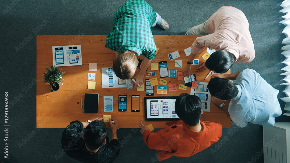 Poster top down view of business team writing idea on sticky note while planing for ux ui design for mobile