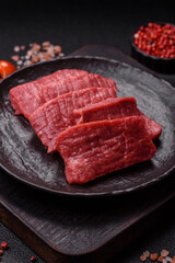 Raw beef tenderloin cut into slices with salt and spices
