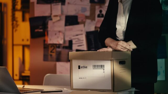 Detective studies old case files, determined to solve a case through research