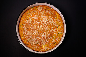 Savory cornbread with sesame seeds on a black background