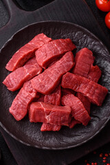 Raw beef tenderloin cut into slices with salt and spices