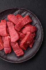 Raw beef tenderloin cut into slices with salt and spices