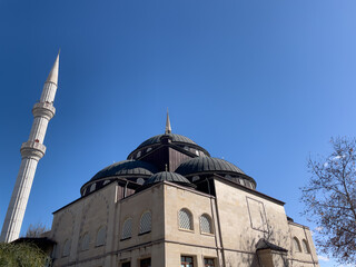 Beautiful Mosque With A Tall Minaret Against A Clear Blue Sky. Symbol Of Islamic Faith And Culture....