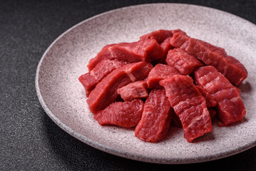 Raw beef tenderloin cut into slices with salt and spices