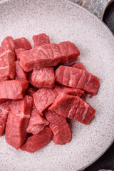 Raw beef tenderloin cut into slices with salt and spices