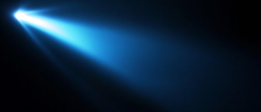 A black background with a beam of bright blue light. Bright blue beam of light cutting through the darkness creating a visual energy effect.