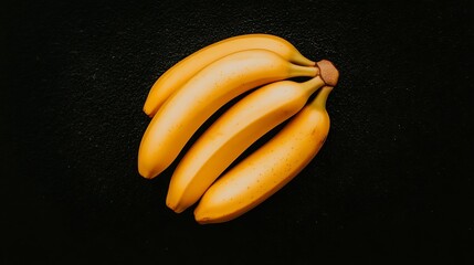 Ripe bananas on black background, a flat lay, for healthy food concepts