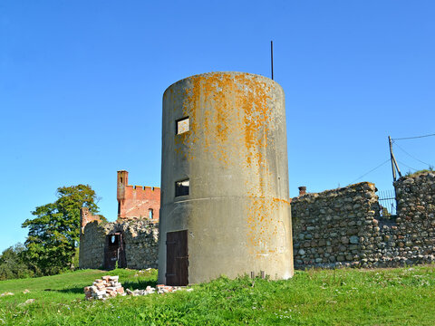 Economic reinforced concrete tower of German construction against the background of Schaaken Castle. Nekrasovo settlement. Kaliningrad region