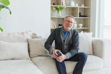 Knee pain arthritis body sick health care concept. Unhappy middle aged senior man suffering from...