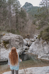 Woman standing in the nature with view over the mountain.