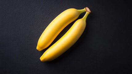Two ripe bananas on dark slate background