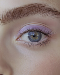 Fototapeta premium Close-up of eye with soft lavender eyeshadow and natural lashes