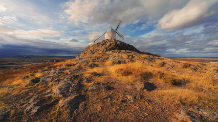 windmill at sunset over the mountains