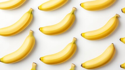 Yellow bananas arranged in a pattern on a white background, potentially used for food or design visuals