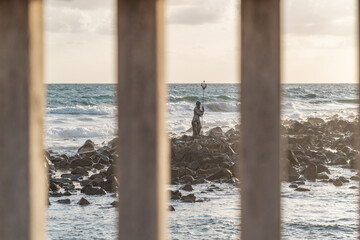 A statue of Neptune in the sea. 