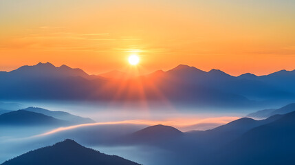 Fototapeta premium Sunrise over the mountains, with mist rising from below and the sun at the center 