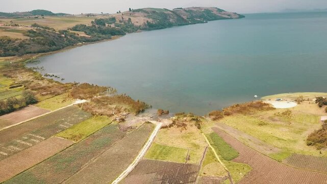 drone flight over a lake surrounded by an onion field. tota lagoon