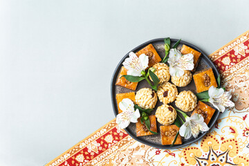 Baklava and traditional sweets on a black plate. A beautiful composition for Nowruz celebrations.