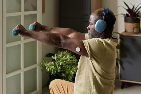 Exercising with Dumbbells While Wearing Headphones