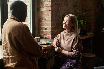Conversing Happily in Cozy Cafe with Natural Light