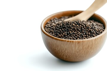 Whole black peppercorns in wooden bowl with spoon on white background, aromatic spice and seasoning ingredient for cooking and food preparation.