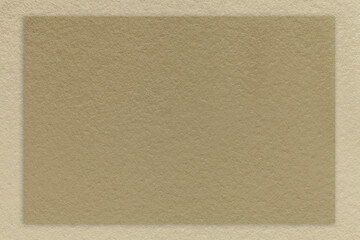 Texture of craft brown color paper background with beige border, macro. Structure of vintage dense kraft sand cardboard