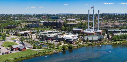 Aerial view of people enjoying the Deschutes River, with Old Mill District in the background. Summer fun on the water.  Bend, Oregon, USA © Zenstratus