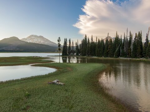 Peaceful scene of a mountain lake at dawn. Hikers enjoy a tranquil morning paddle. Nature's beauty. Sparks Lake, Bend, Oregon, USA