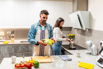 Couple preparing healthy meal together in modern kitchen