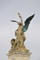 Statue of an Angel Holding a Key and Guarding a Fallen Figure