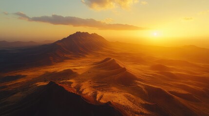 Naklejka premium Golden Sunrise Over Majestic Mountain Range in Serene Desert Landscape