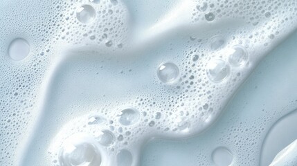 White foam bubbles creating textured patterns on light blue surface, showcasing varying sizes and shapes, symbolizing cleanliness, hygiene, skincare concept