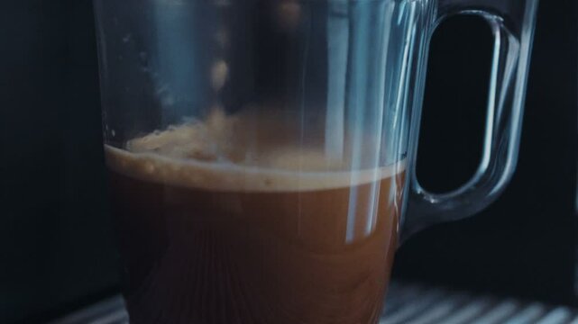 Drink concept: closeup shot of street coffee machine cooking coffee beverage espresso capuccino latte hot cholocate, coffee flows down to transparent cup. Shot on RED Epic Camera.
